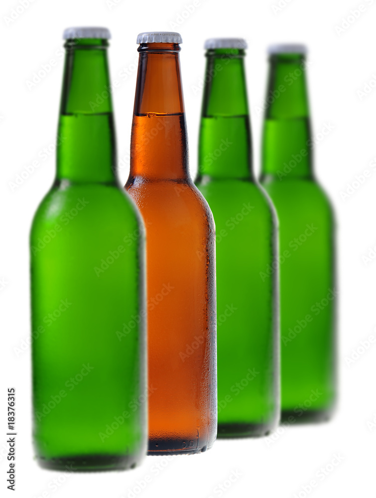 A row of beer bottles with one different from the others A row of beer bottles with one different from the others