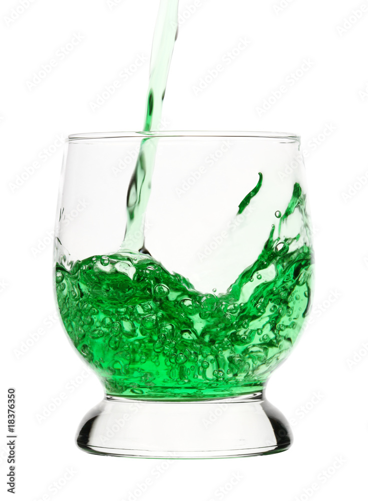 Green drink is being poured into glass Green drink is being poured into glass
