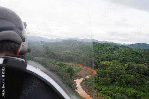 Autogyro flying over the tropical landscape photo