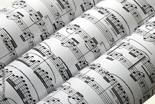 Three music sheets on a row isolated in white