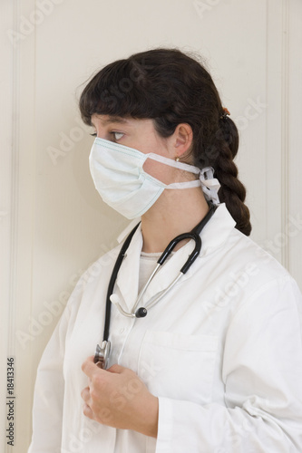 Femme médecin en blouse blanche avec masque anti-grippe