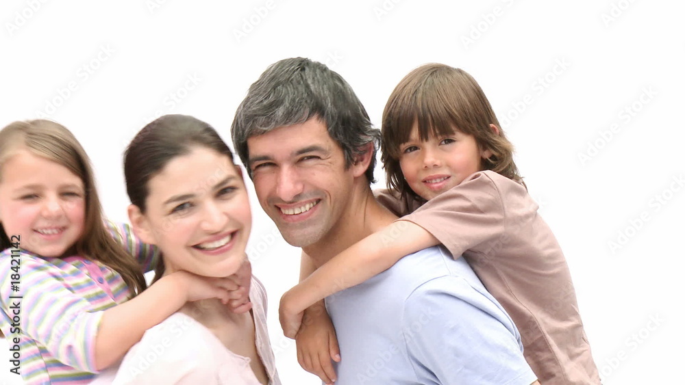 Parents giving children piggyback ride Parents giving children piggyback ride