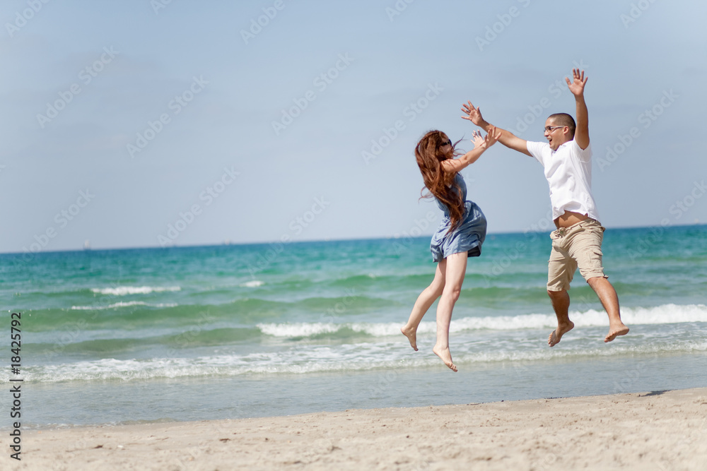 Happy young couple having fun on the beach Happy young couple having fun on the beach