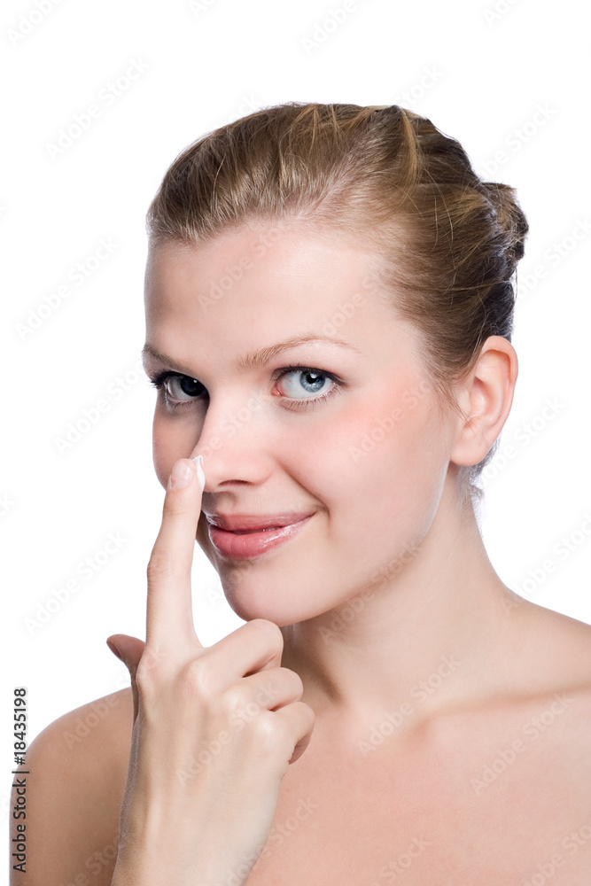 women applying cream to her nose