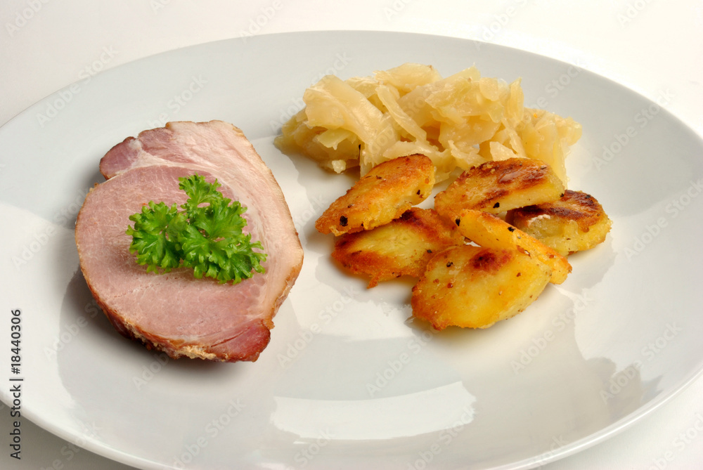 cooked organic back bacon joint with white cabbage