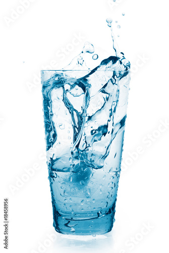Water splash in a glass. Glass is isolated on white.