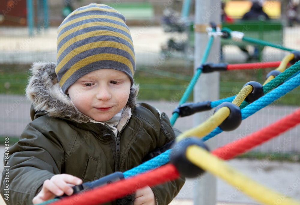 boy playing outdoor at the Children's playground boy playing outdoor at the Children's playground
