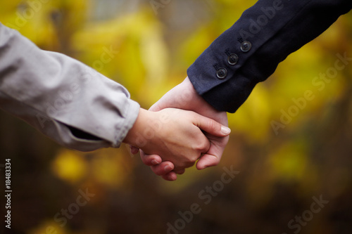 Romance - Couple holding hands in fall