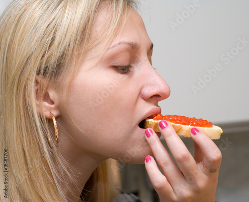 Girl with an open sandwich.