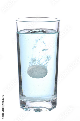 Tablet in glass on a white background