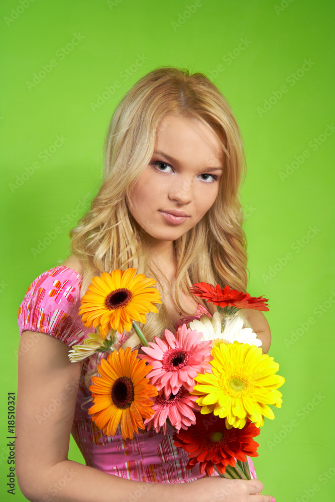 Beautiful young blonde girl with flower