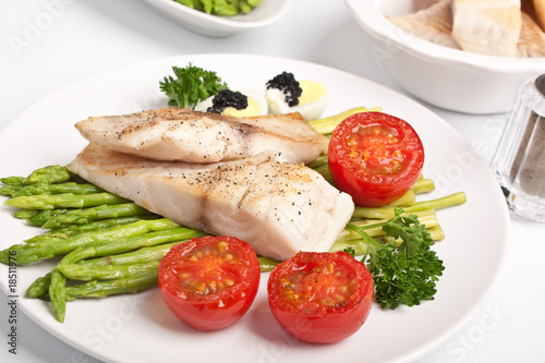 healthy fish fillet with asparagus and tomatoes