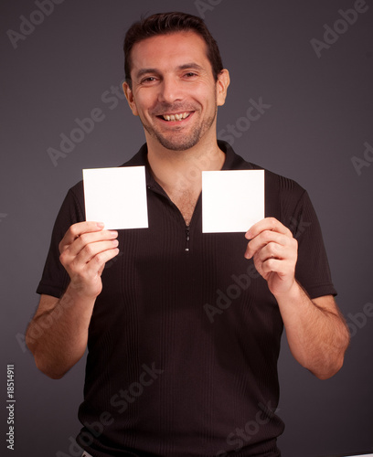 Cheerful man holding two bl...