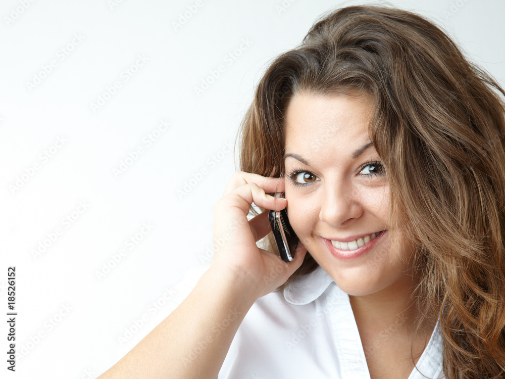 beautiful girl smiling and using her cell phone beautiful girl smiling and using her cell phone