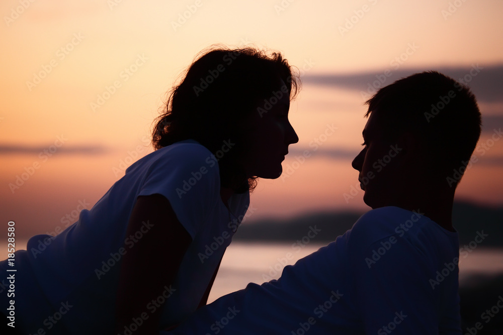 silhouette man and woman on beach