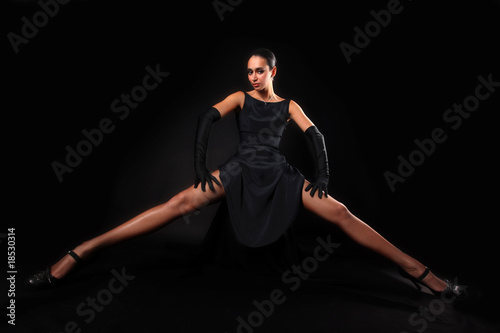 girl with long legs against black background © konstantant