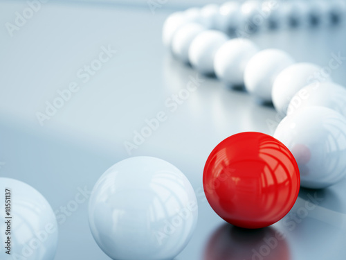 blurred white balls and red ball is in focus