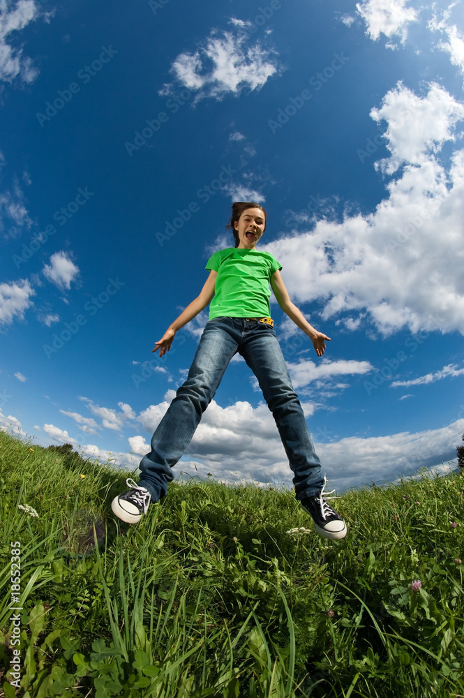 Girl jumping outdoor against blue sky Girl jumping outdoor against blue sky