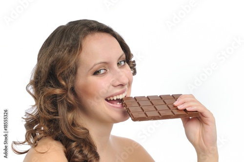Young beautiful woman eating chocolate