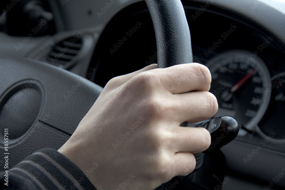 Hand on a car wheel