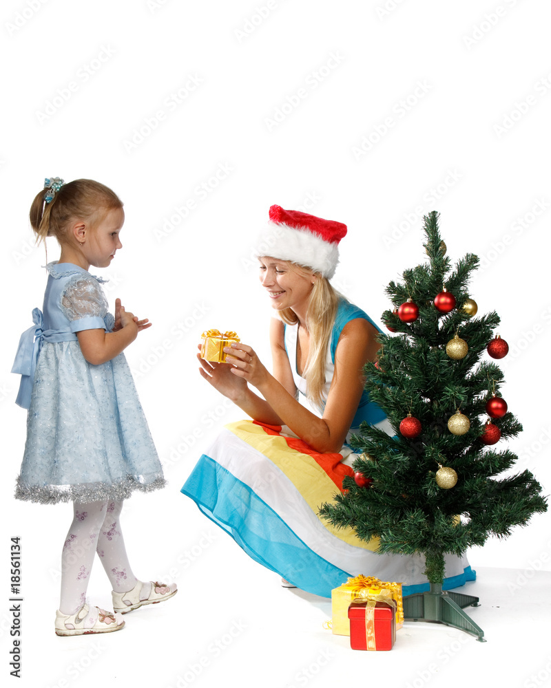 Mum and the daughter with gifts near a Christmas tree. Mum and the daughter with gifts near a Christmas tree.