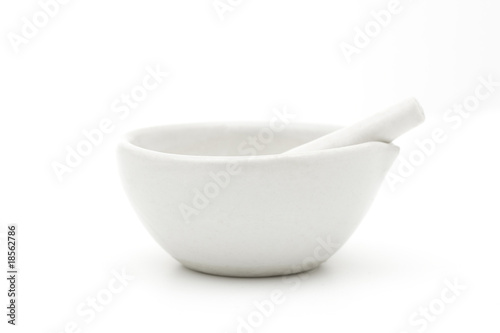 White mortar and pestle over white background photo