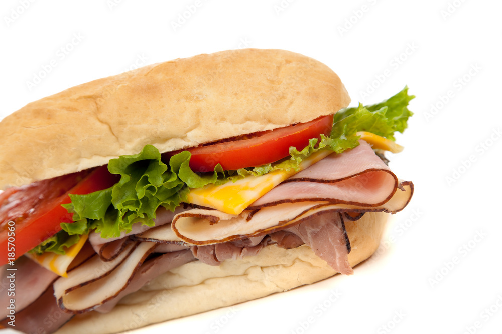 Assorted meat sandwich with fixings on a hoagie Assorted meat sandwich with fixings on a hoagie