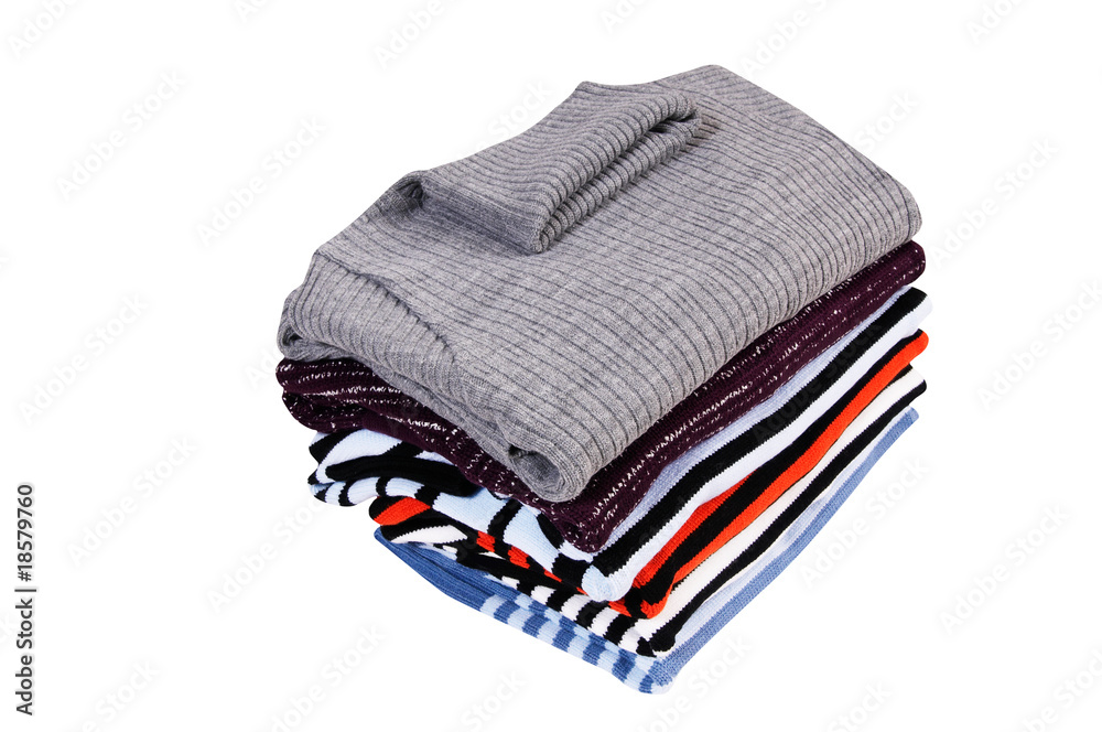 Heap of  sweaters on a white.