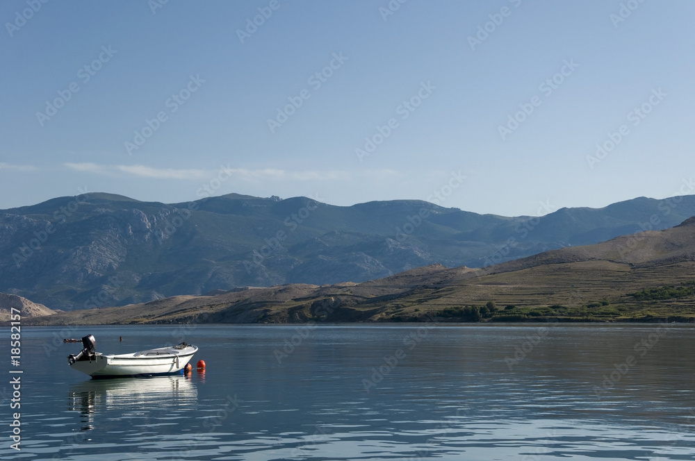 Adriatic Sea bay with a boat and mountains