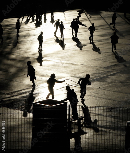 Silhouettes of children playing photo