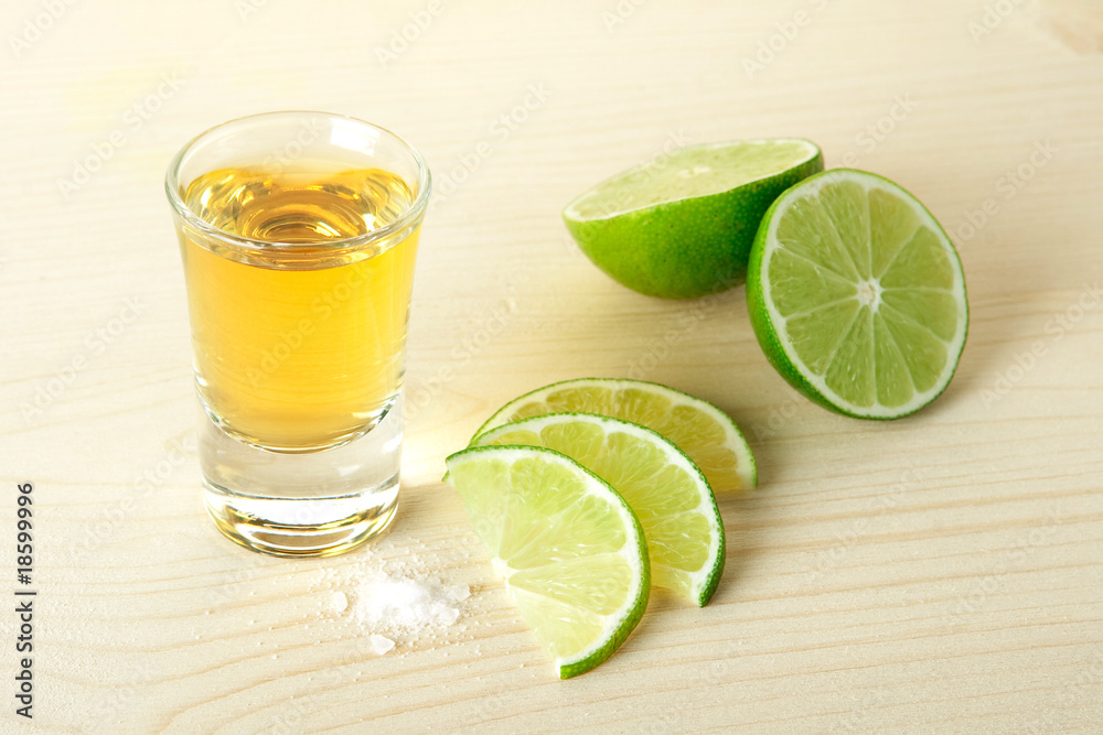 Gold Tequila with lime slices and salt Gold Tequila with lime slices and salt