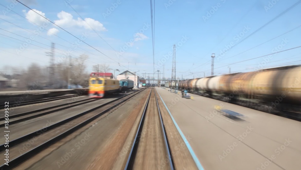 small train station, tracks and cisterns from moving train small train station, tracks and cisterns from moving train