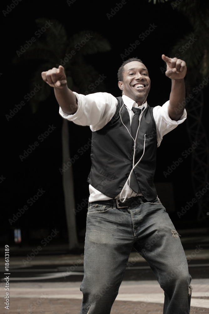 Young black man dancing at night