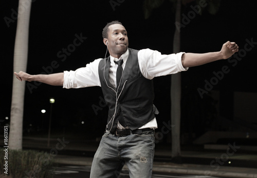 Young Black man dancing in the streets at night