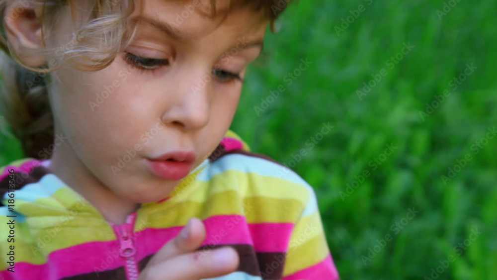 little girl talking on green grass background little girl talking on green grass background