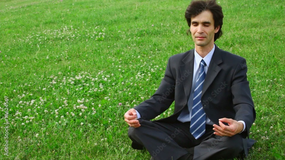 handsome man sitting in pose of lotus handsome man sitting in pose of lotus