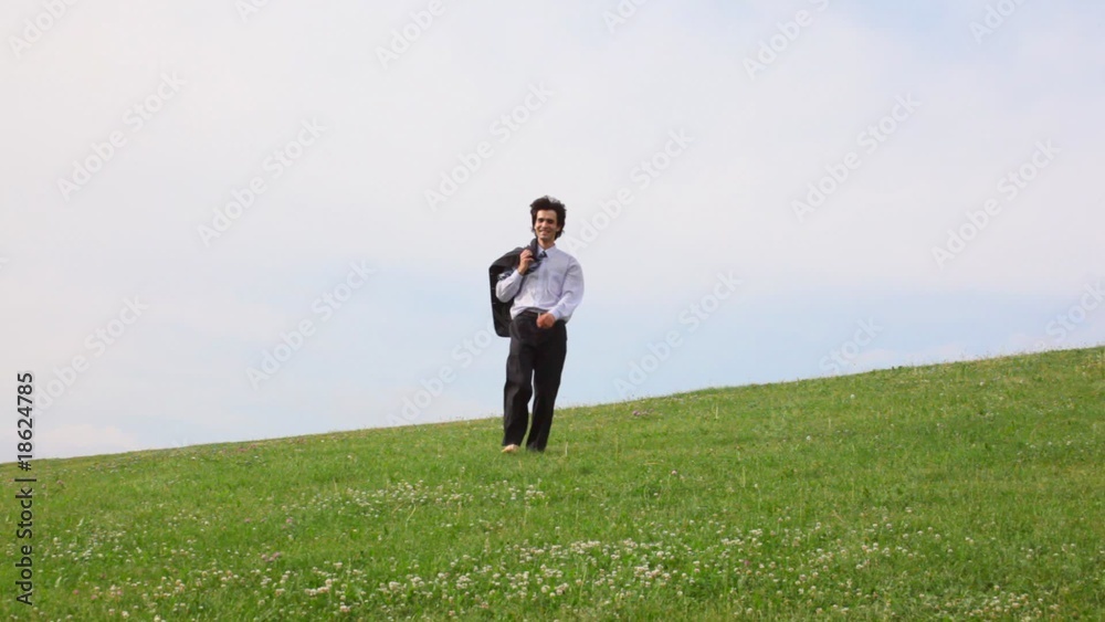 handsome man without shoes walking on green grass, to camera handsome man without shoes walking on green grass, to camera