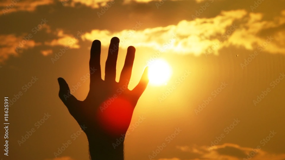 Silhouettes of one hand against the sun Silhouettes of one hand against the sun