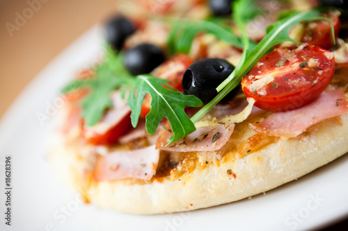 Pizza with cherry tomatoes and black olives