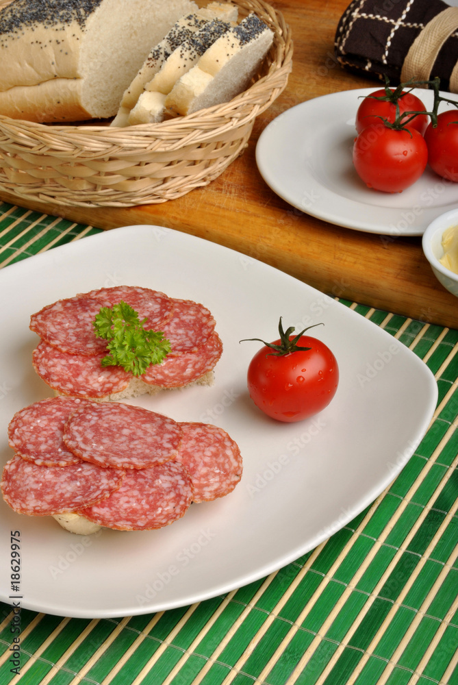 slice poppy seed bread with salami on a plate slice poppy seed bread with salami on a plate