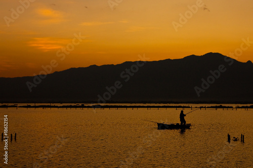 Fisherman in Payao lake, north of Thailand
