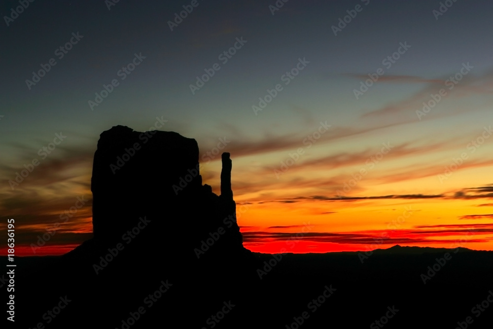 Landscape of a dramatic sunrise with rock formations silhouetted