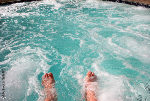 Dipping toes in warm bubbly hot tub