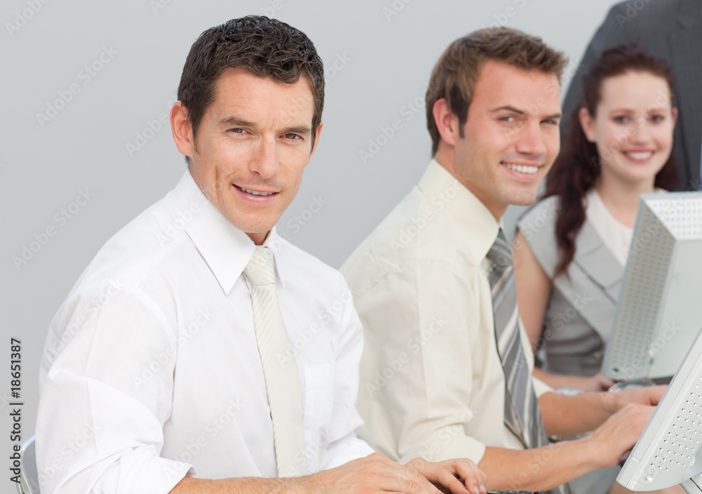 Business people using computers in an office Business people using computers in an office