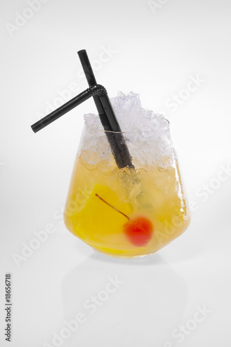Yellow Cocktail with ice and red berry