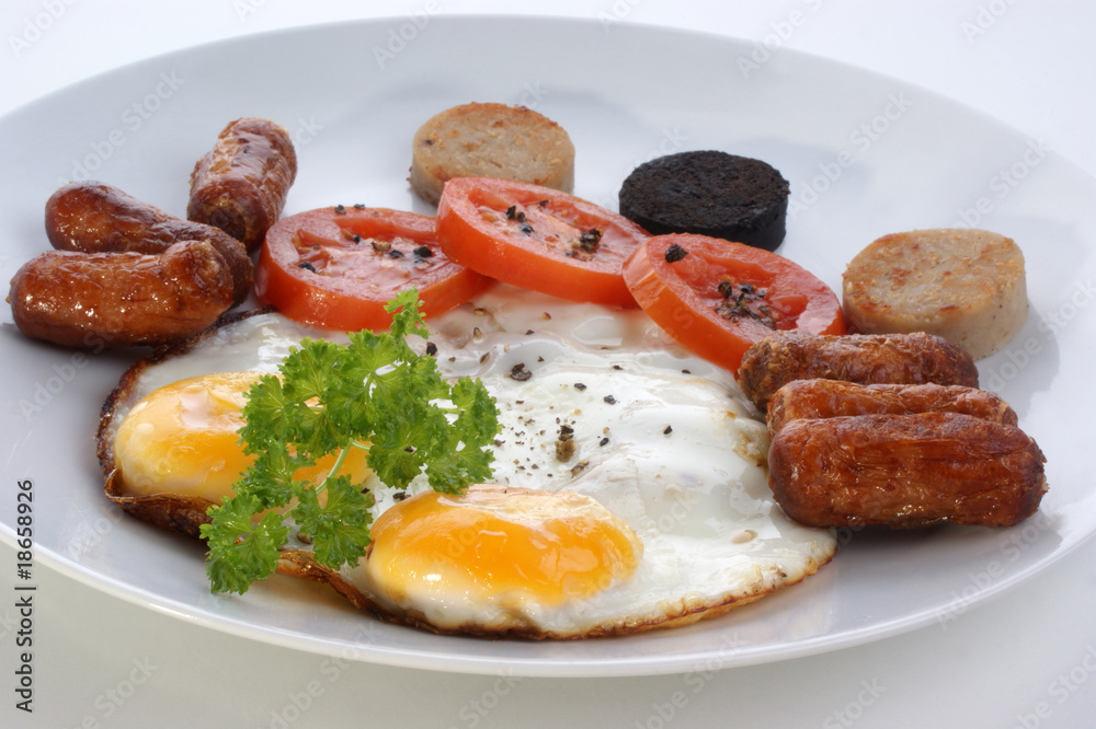 irish breakfast on a white plate with tomato irish breakfast on a white plate with tomato