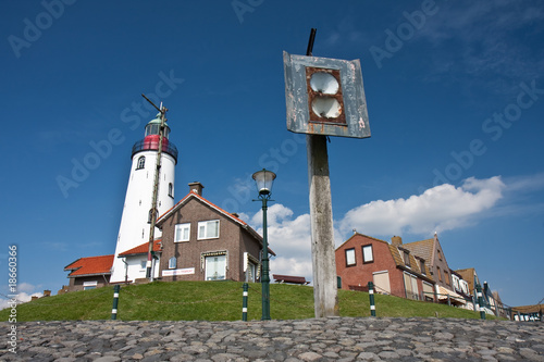 фотографія Seafront with the lighthouse and an  old foghorn of the fishing