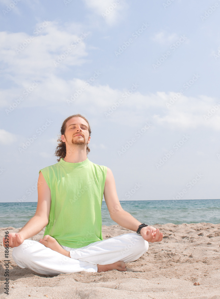 man meditating by the sea