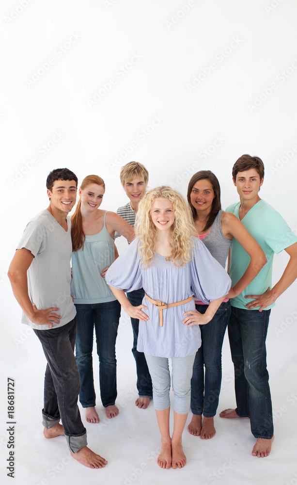 Group of friends standing against white background with copy-spa