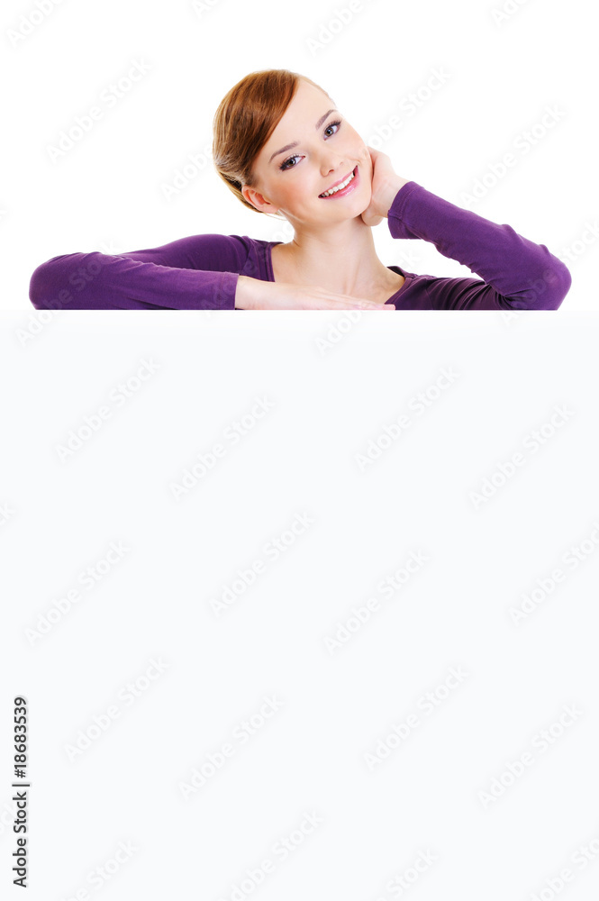 nice smiling femalel is over an empty publicity board nice smiling femalel is over an empty publicity board